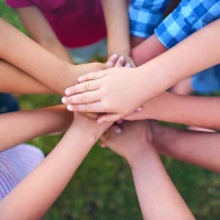 Group of people joining hands