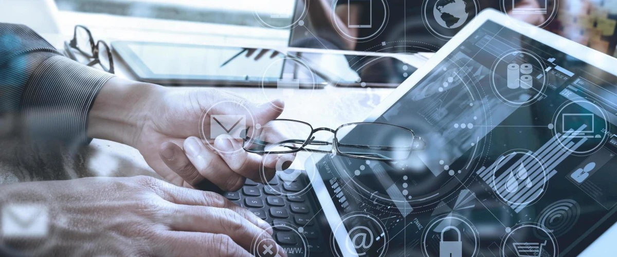 Person wearing glasses working on laptop