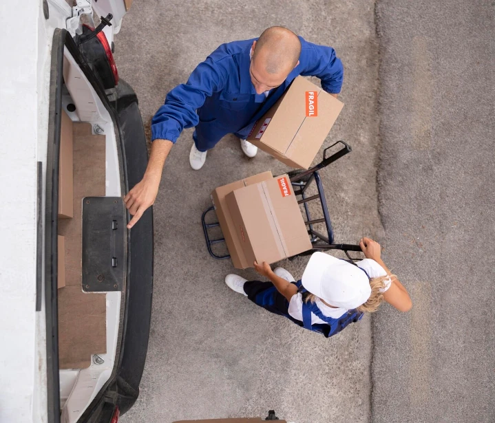 People unloading boxes from a truck