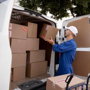 Person loading boxes into a van